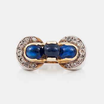 1297. A cabochon-cut sapphire and brilliant-cut diamond ring.Total carat weight of diamonds circa 0.45 ct.
