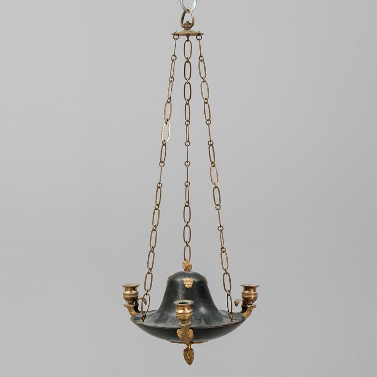 A Swedish Empire style 20th century three-light patinated brass hanging-lamp.