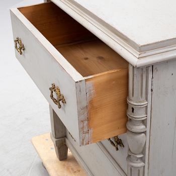 A painted chest of drawers from around the year 1900.