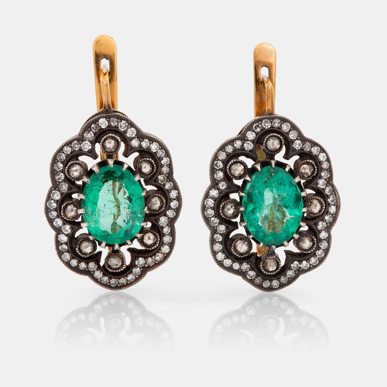 A pair of earrings with diamonds and emeralds. Russian setting.