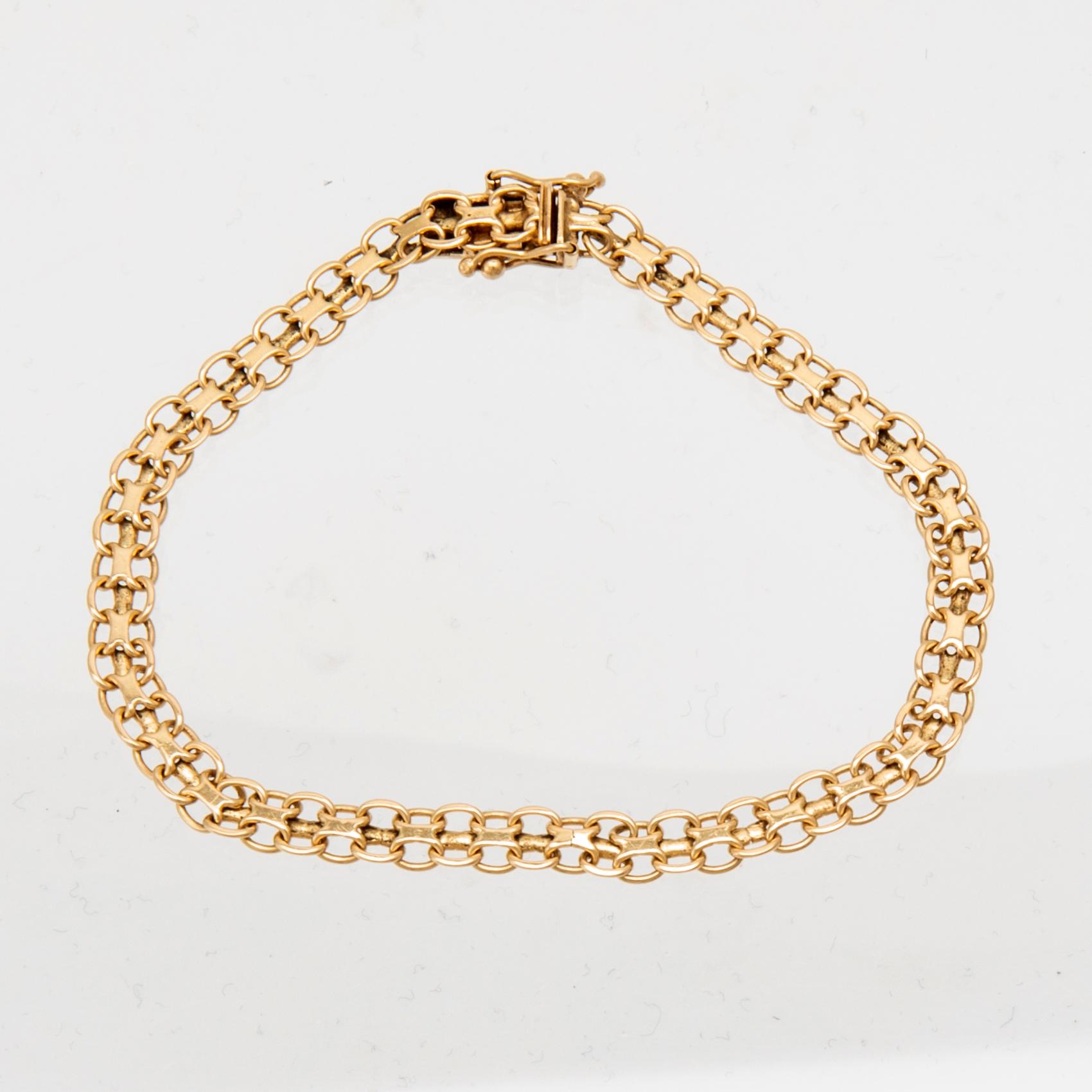 An 18K gold x-link bracelet.