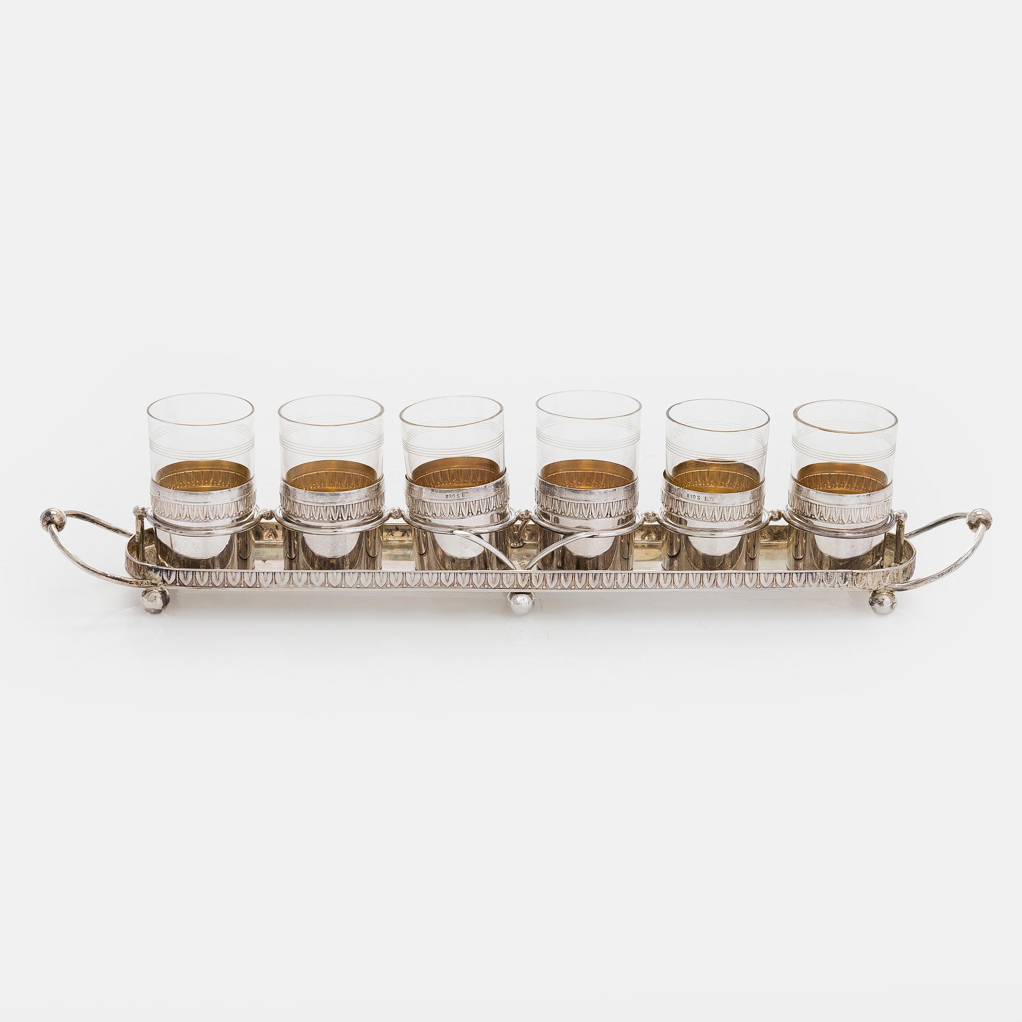 A set of six shot glasses with a tray in original fitted box, silver and glass, likely Norway 1910s.