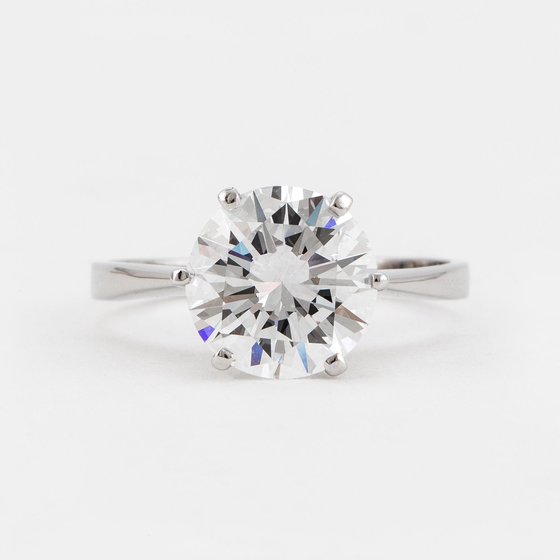 A SOLITAIRE RING set with a round brilliant-cut diamond.