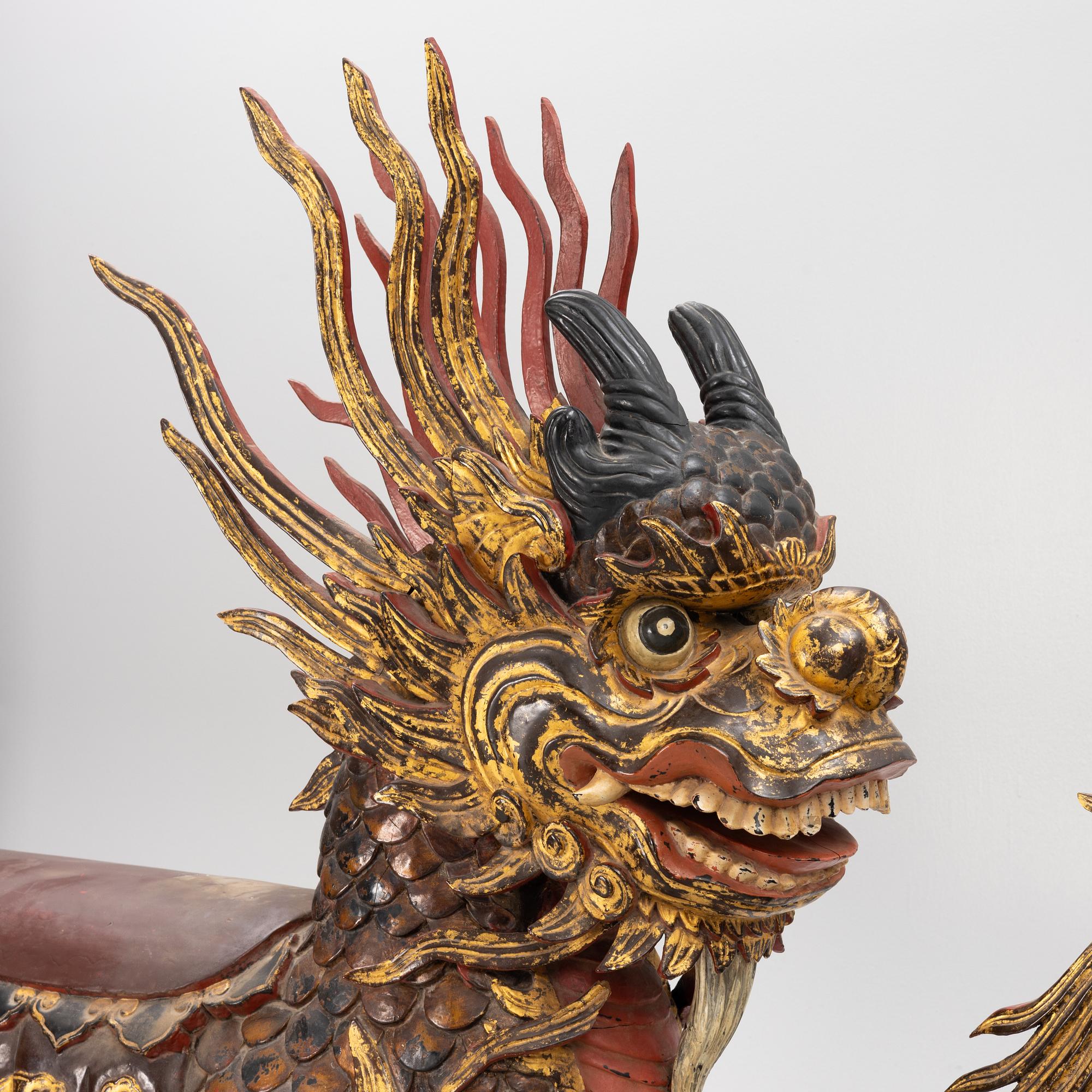 A pair of large Qilin sculptures, lacquered wood, first part of the 20th century.