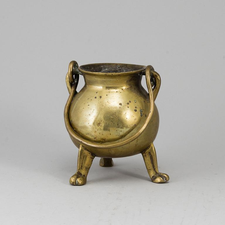 A 17th century brass bowl.