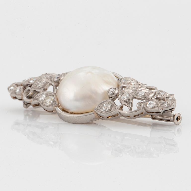 A platinum brooch set with a pearl and old- and rose-cut diamonds.