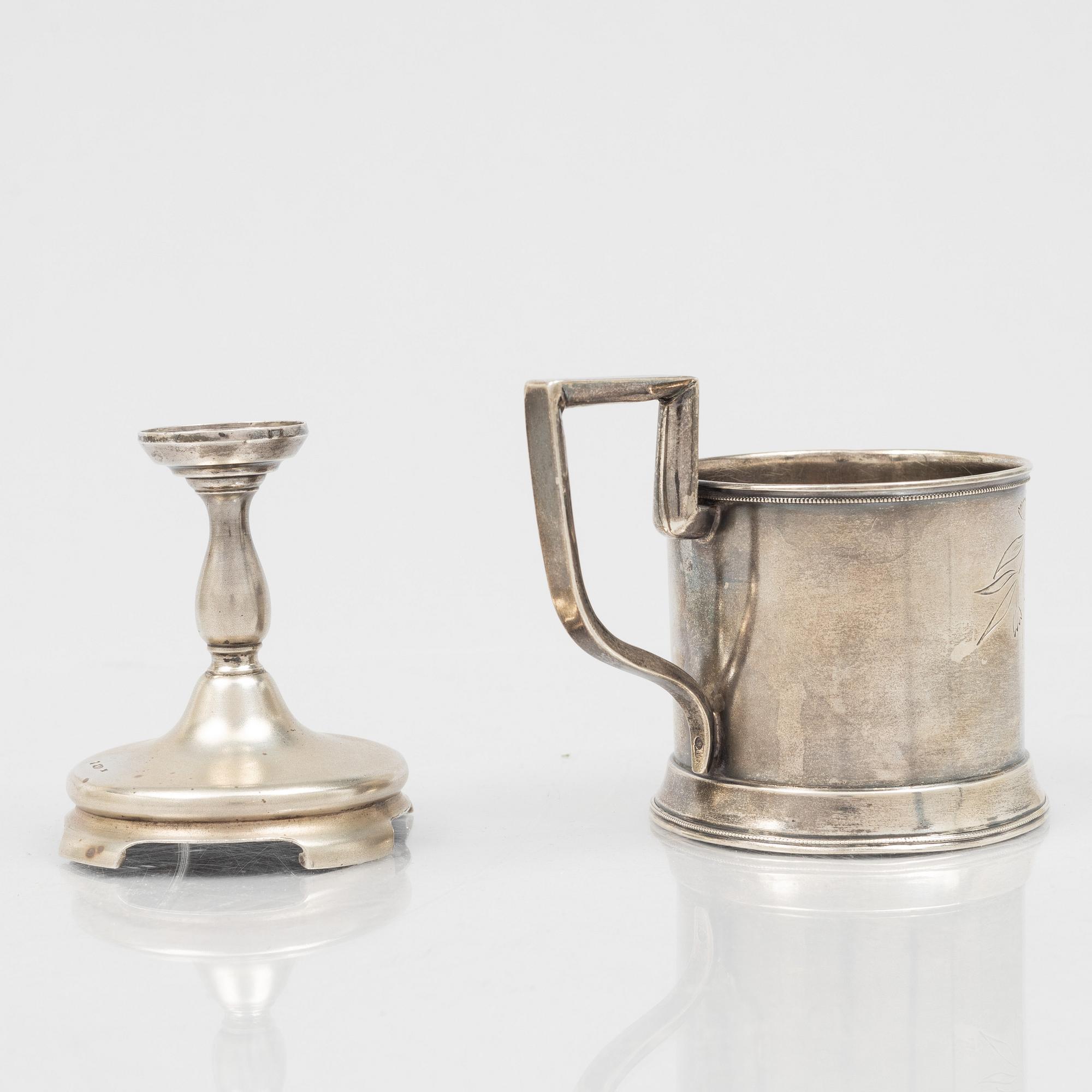 A Russian Silver Candlestick, 1908-26, and a Russian Silver Tea Glass Holder, assay master A. Skovronsky, Moscow 1896.