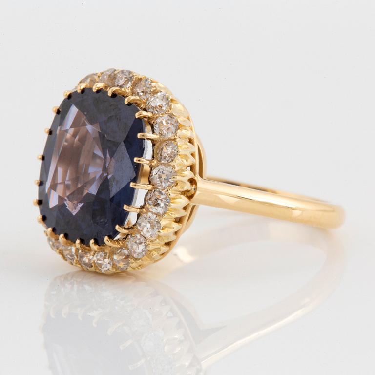 An 18K gold ring set with a cushion-cut purple spinel 6.15 cts according to information given.