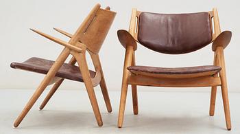 A pair of Hans J Wegner oak and brown leather easy chairs, Carl Hansen & Son, Denmark 1950's-60's.