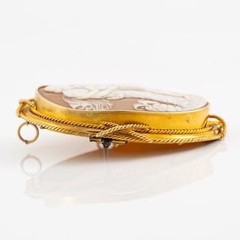 A brooch with a large shell cameo.
