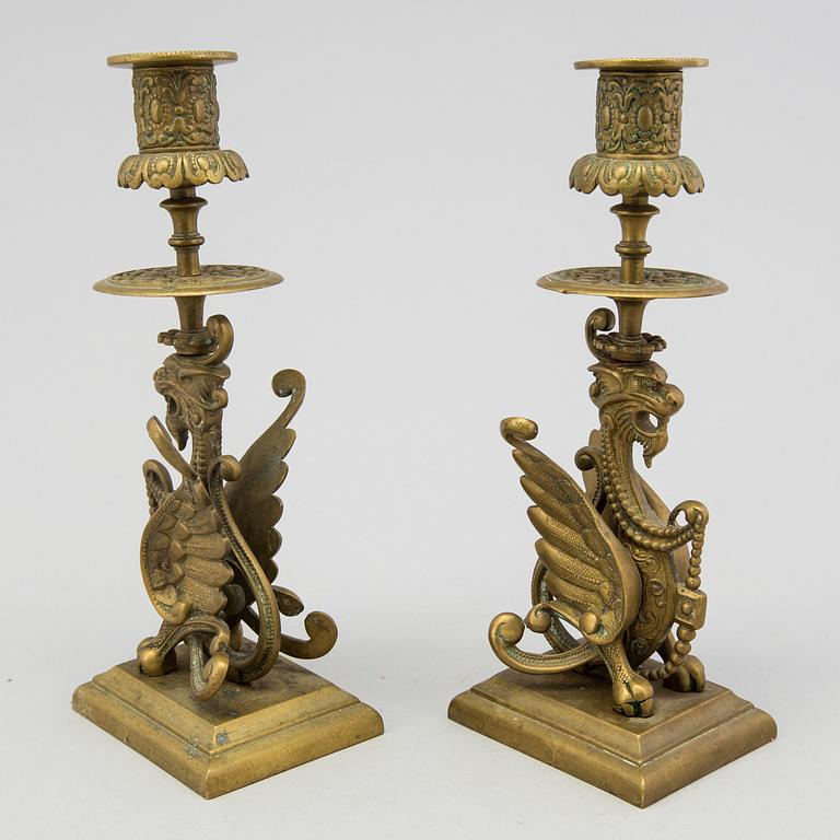 A pair of brass candle sticks late 19th century.