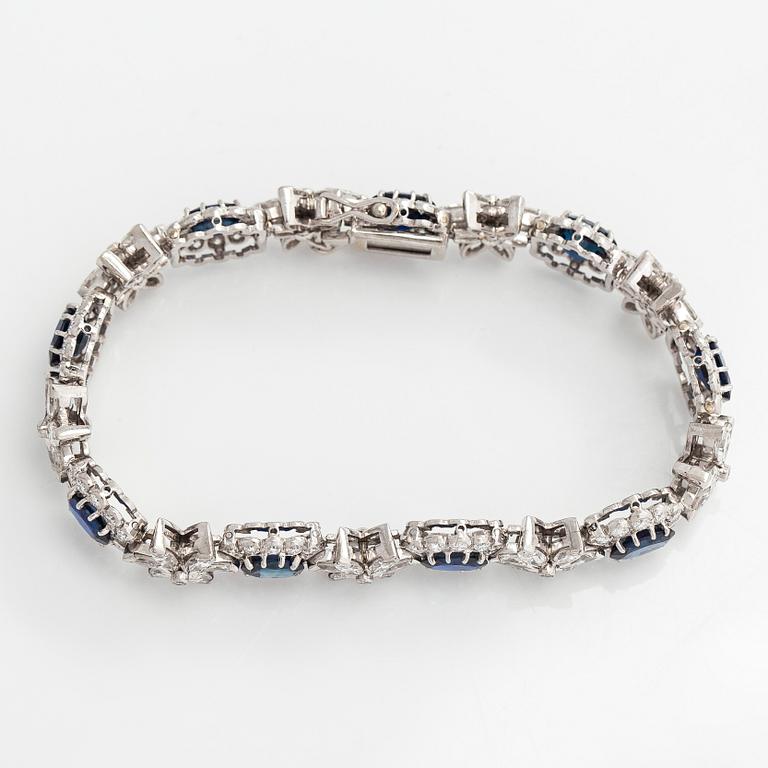 A platinum bracelet, set with oval faceted sapphires and brilliant-, marquise-, and single-cut diamonds.