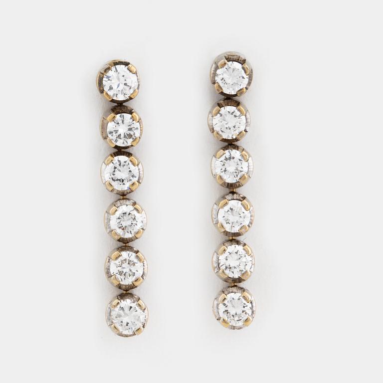 A pair of brilliant cut diamond earrings.