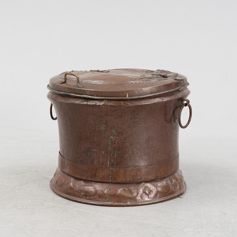 A copper water container, dated 1706.