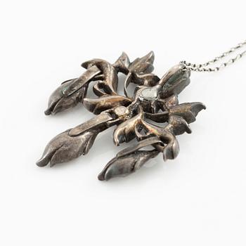 A brooch, a brooch pin, and a pendant, likely 19th century.