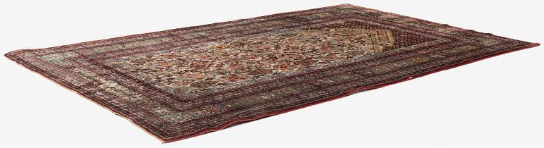 A semi-antique silk Qum rug, central Persia 221 x 138 cm.