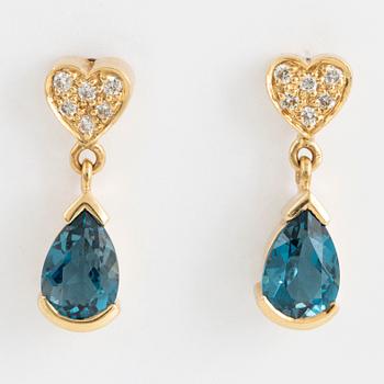 Drop shaped blue topaz and brilliant-cut diamond earrings.