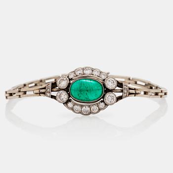 694. A cabochon cut emerald and brilliant cut diamond bracelet. Total carat weight of diamonds circa 1.10 cts.