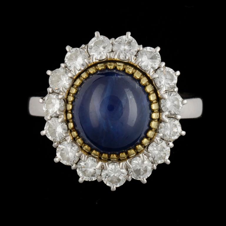 A cabochon cut blue sapphire and brilliant cut diamond ring, tot. ca 1.20 cts.