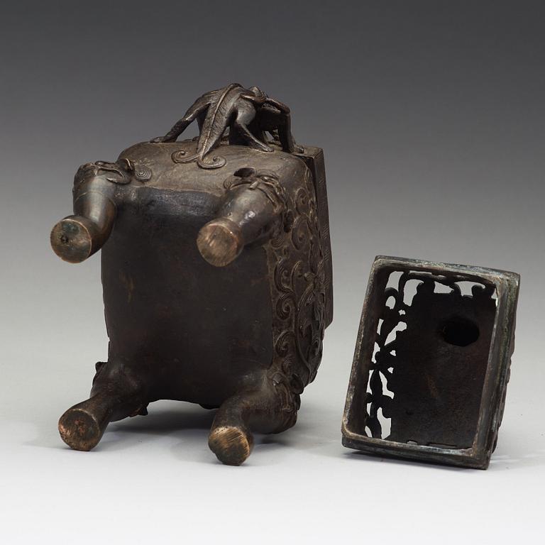 A Chinese bronze incense burner with pierced cover, Qing dynasty, 17th/18th century.