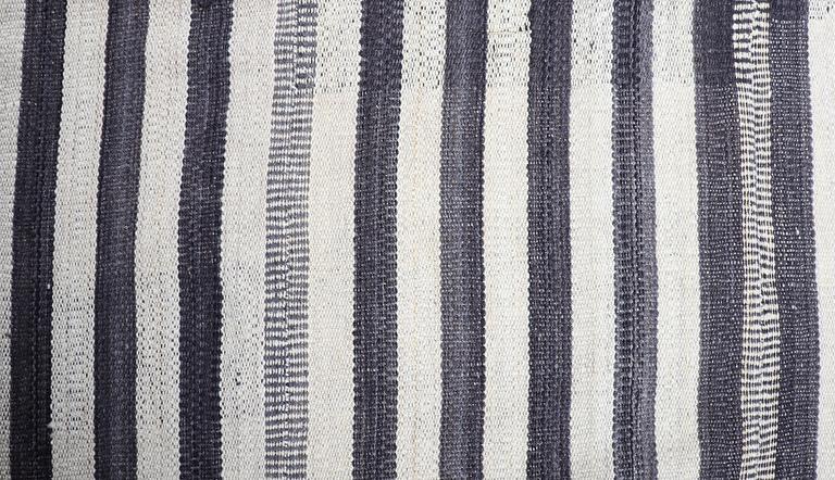 A FLATWEAVE RUG, 292 x 246 cm.