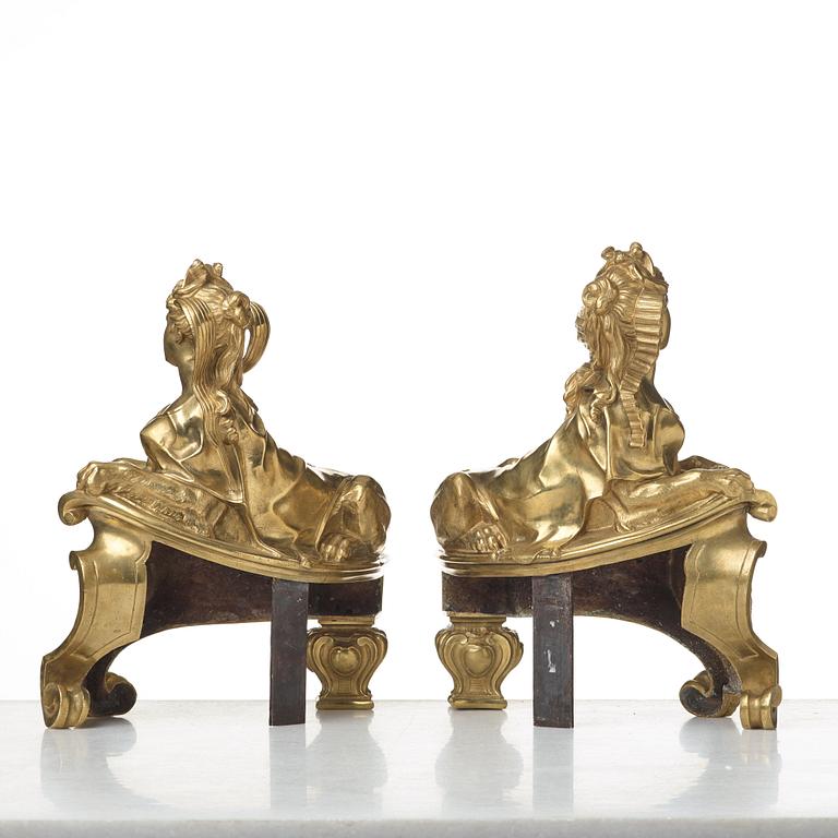 A pair of Louis XV fire dogs, France, mid 18th century, the design of the sphinxes attributed Nicolas Coustou 1658-1733.