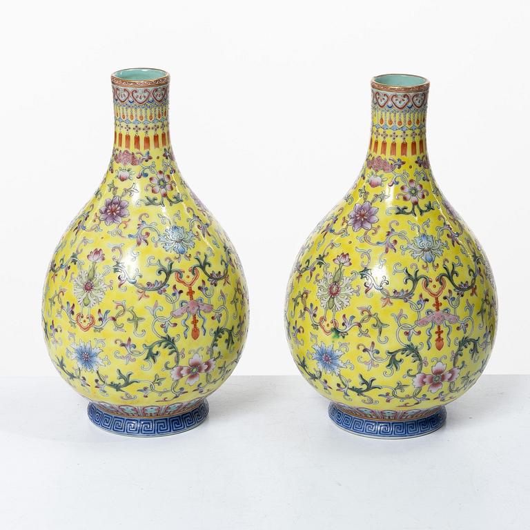 A pair of Chinese yellow ground porcelain vases, 1900s.