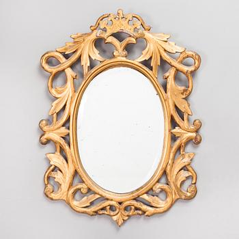 A gilded and bronzed woodcut leaf decorated mirror, second half of the 19th century.
