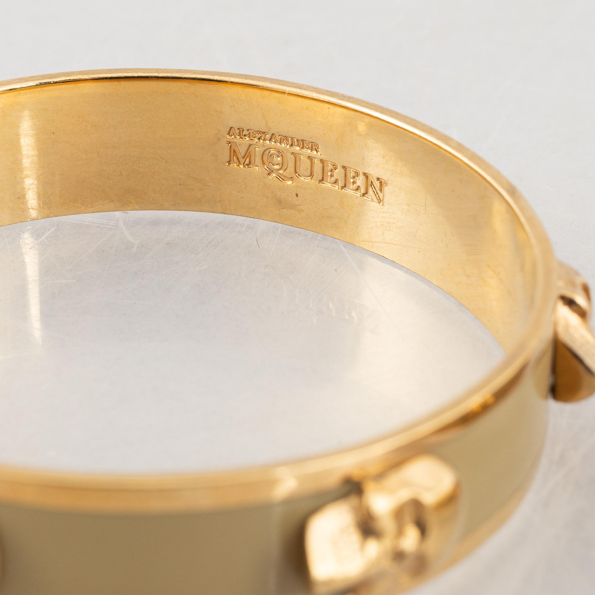 Alexander McQueen, three bracelets and a ring.