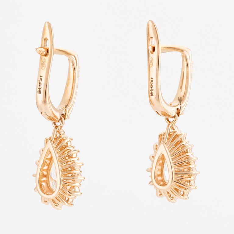 A pair of earrings in 18K gold with two drop-shaped brilliant-cut diamonds.