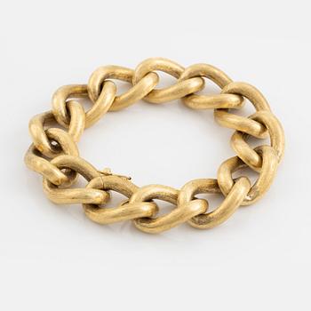 An 18K gold bracelet.