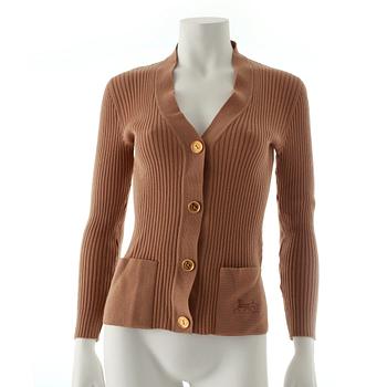 CÉLINE, a beige cardigan.