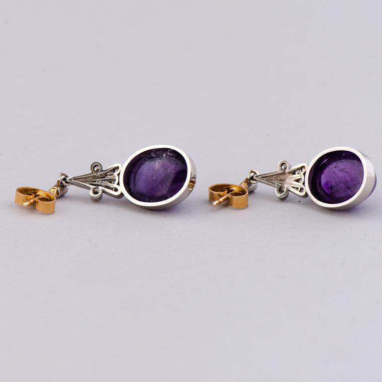 A NECKLACE, BRACELET, EARRINGS and RING, amethysts, diamnonds, 18K white gold and palladium. A. Tillander, 1970s.