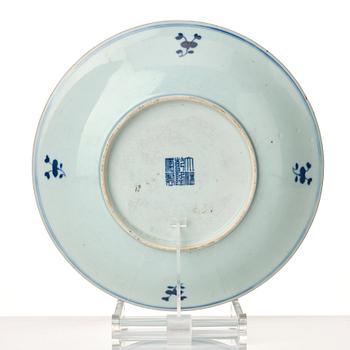 A blue and white dish with immortals and boys, late Qing dynasty, circa 1900.