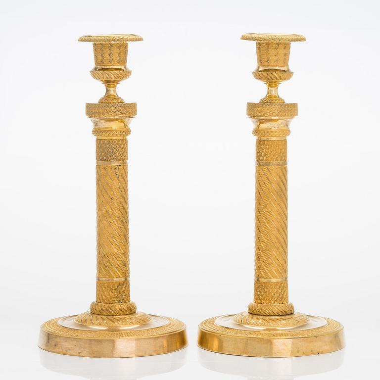 A pair of  French gilded Empire candlesticks, early 19th century.