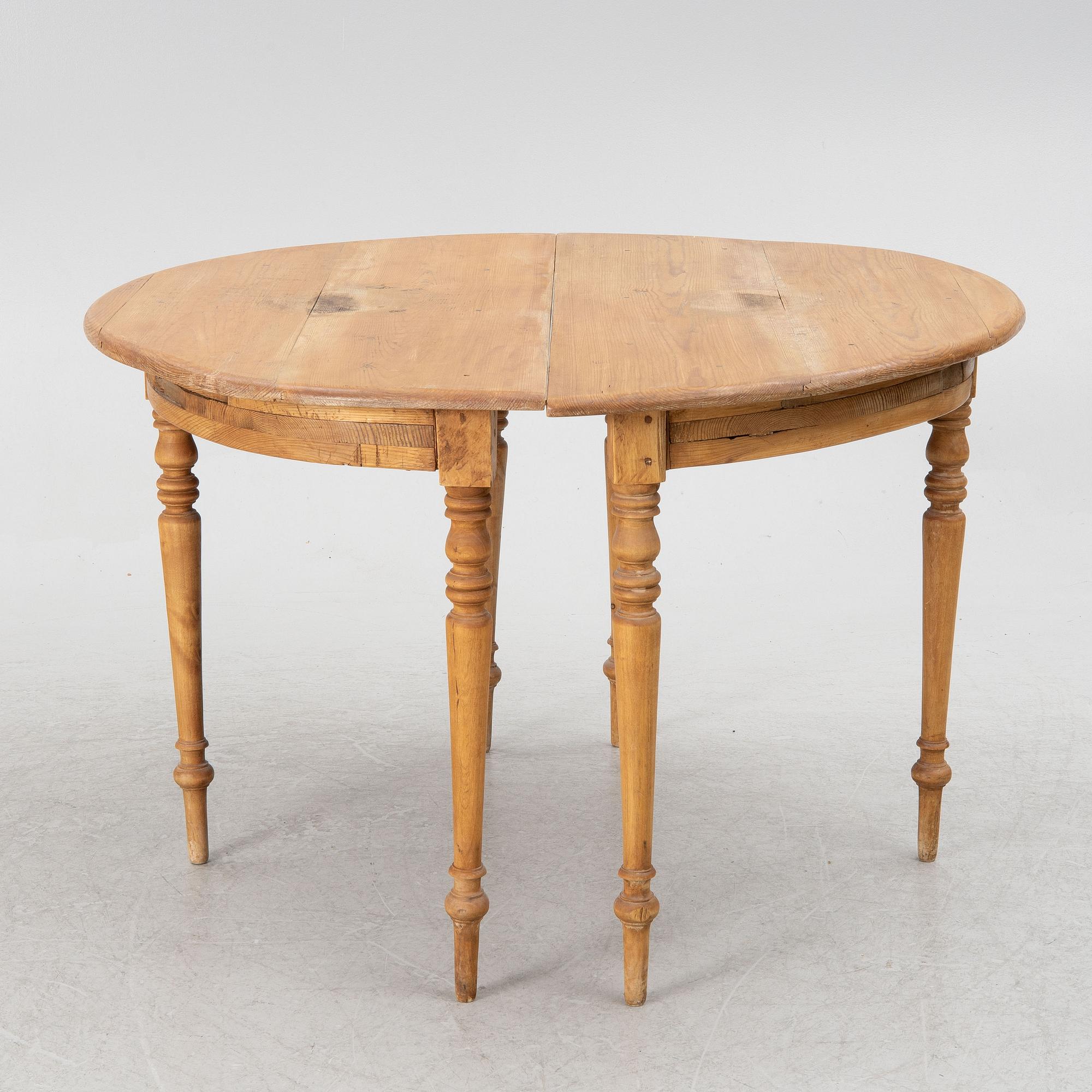 A round pine dining table/a pair of crescent shaped tables, Sweden, 19th century.