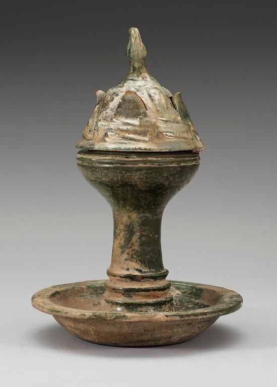 A green glazed pottery Hill Jar, cover with bird shaped finial, Han dynasty (206 BC-AD 220).
