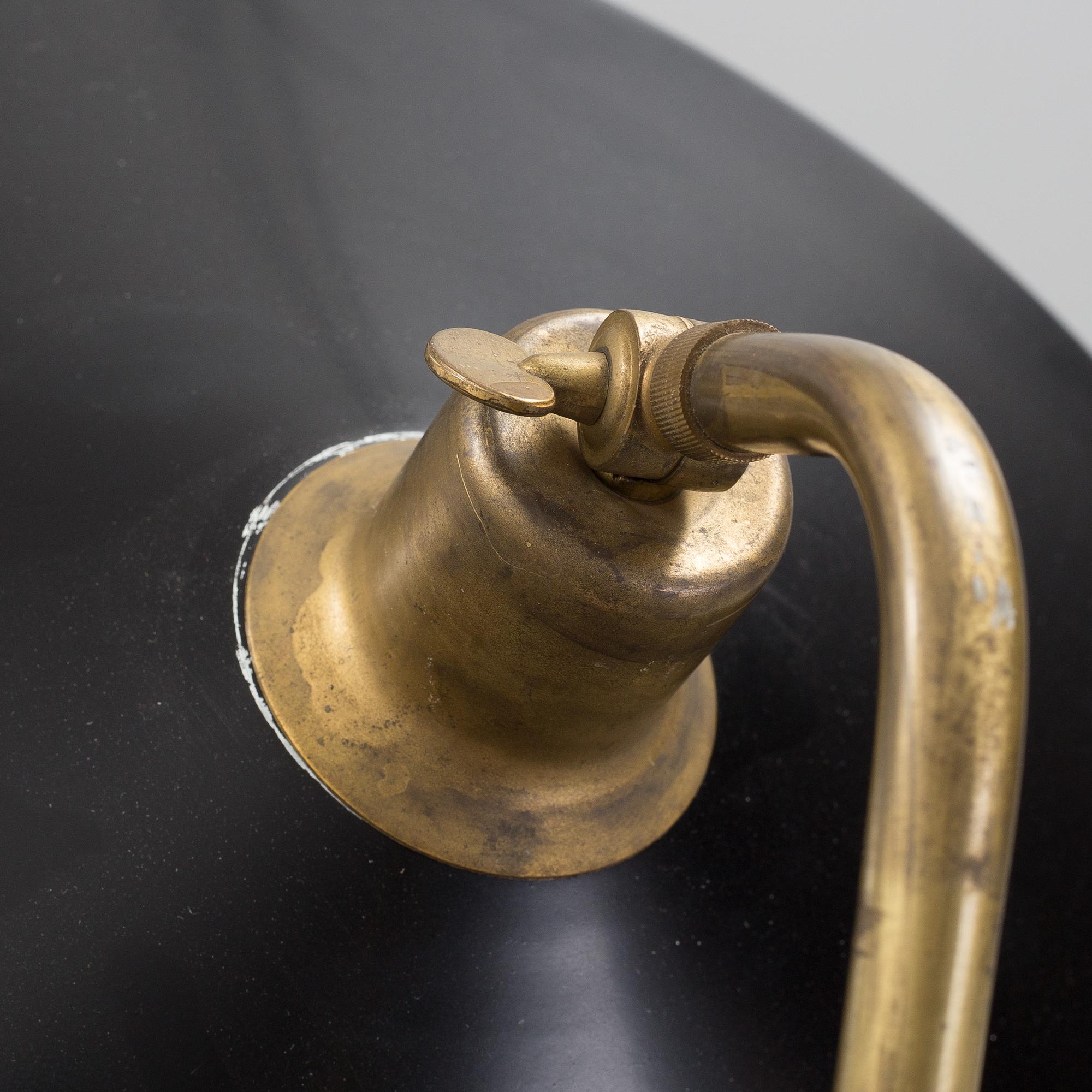 A 20th century brass and painted metal swing-arm wall light.