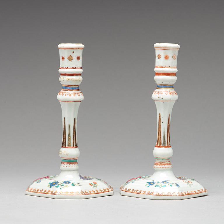 A pair of famille rose candle sticks, Qing dynasty, Qianlong (1736-95).