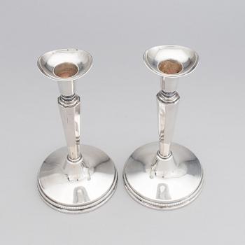 A pair of silver candle stick holders by Erik Löfman, MGAB, Uppsala, 1976.