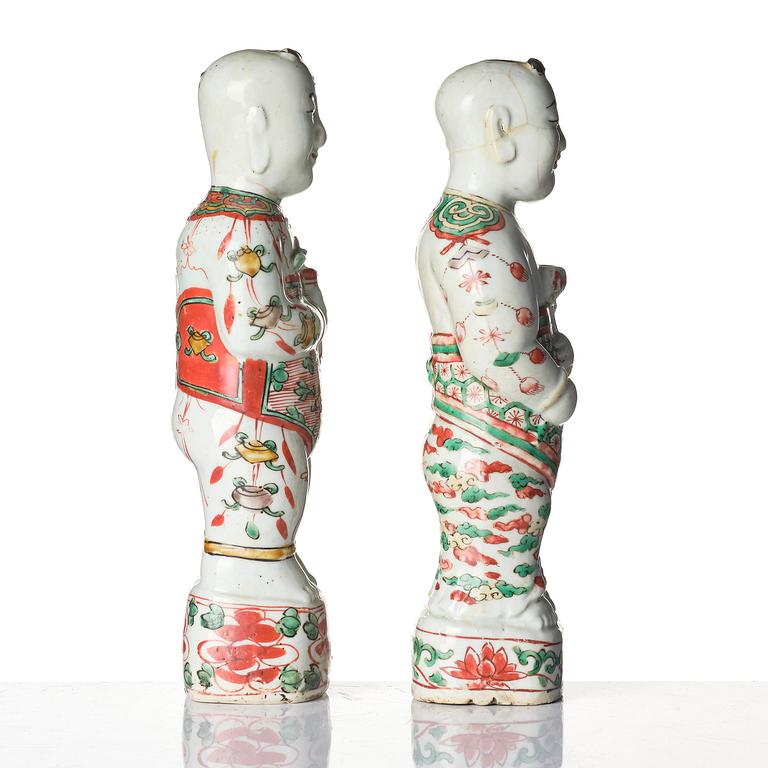 Three Chinese famille verte figures of laughing boys 'Hehe Erxian', 18th century.