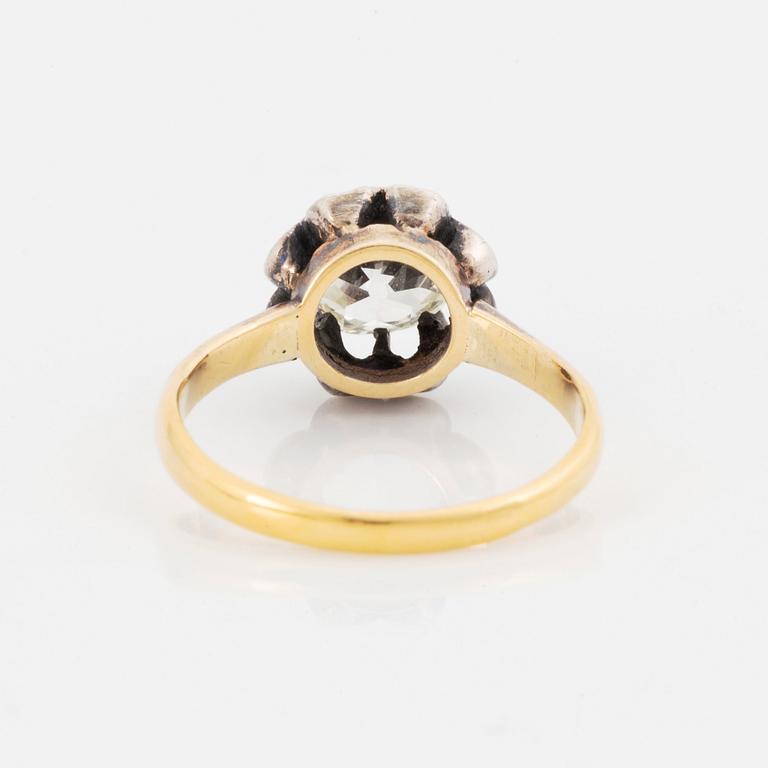 An 18K gold and silver ring set with an old-cut diamond.