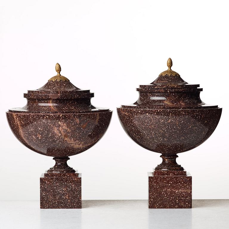 A pair of late Gustavian early 19th century porphyry urns with cover.