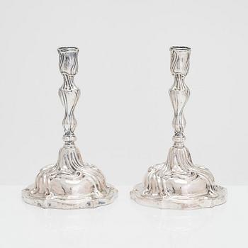 A pair of 18th-century Rococo silver candlesticks from Germany with later candelabra arms. Unindtified maker's mark.