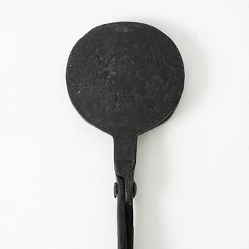 An iron wafer maker, dated 1662.