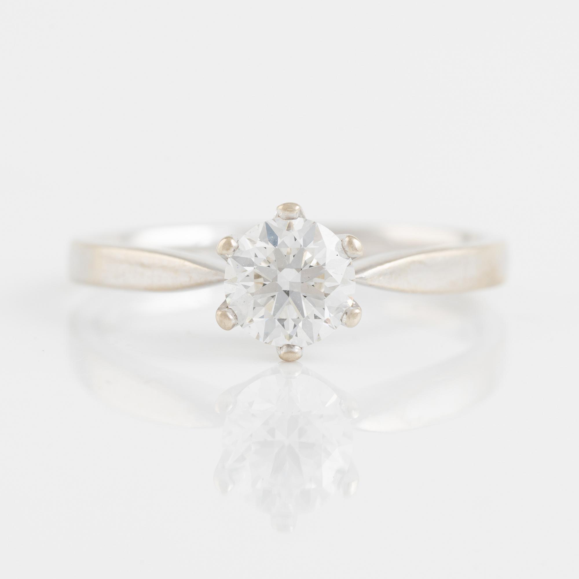 A 14K gold ring set with a round brilliant-cut diamond.