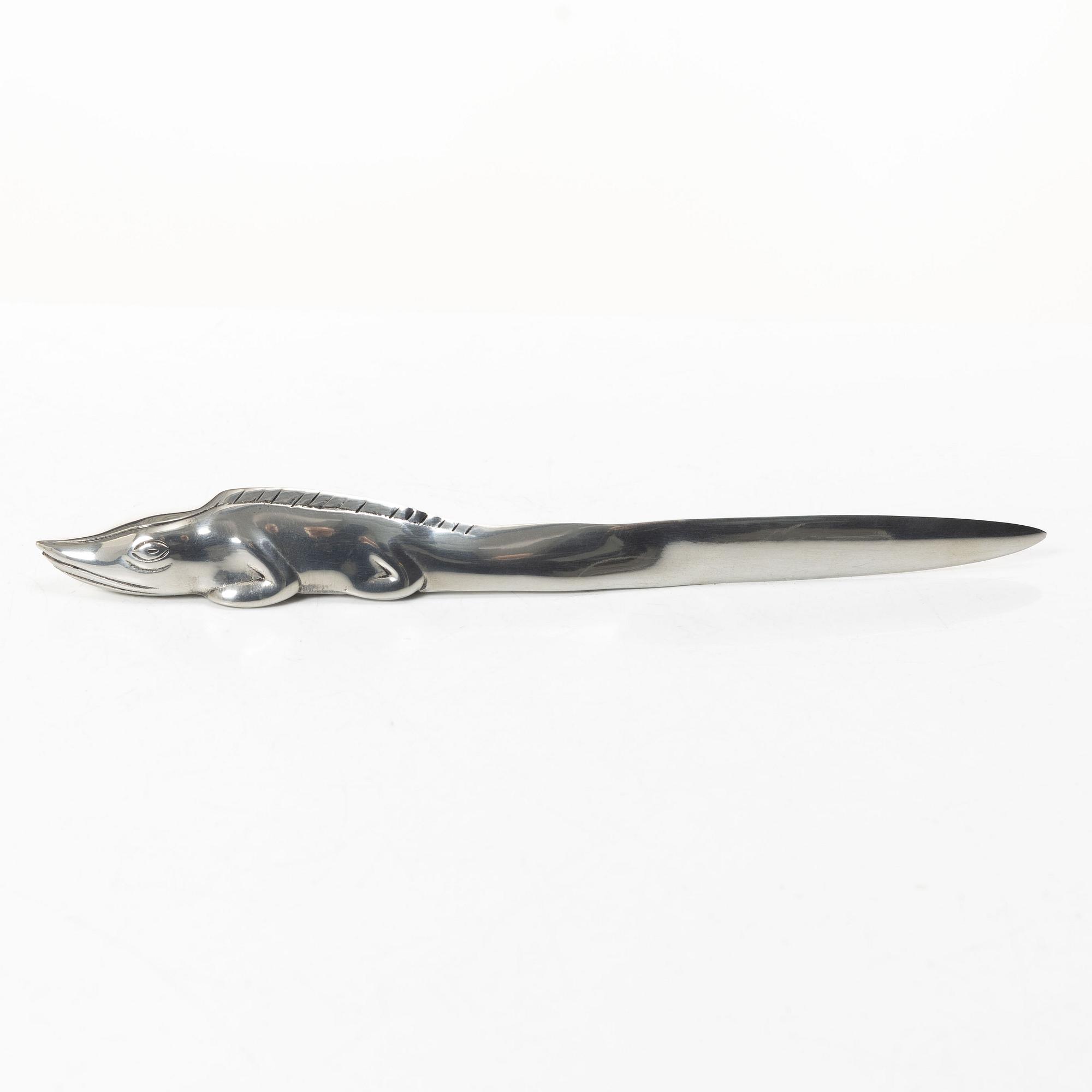 Firma Svenskt Tenn, Candelabrum, 'Vänskapsknuten', and paper knife, 'Alligator'.