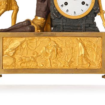 A figural Empire ormolu and patinated bronze mantel clock, early 19th century.