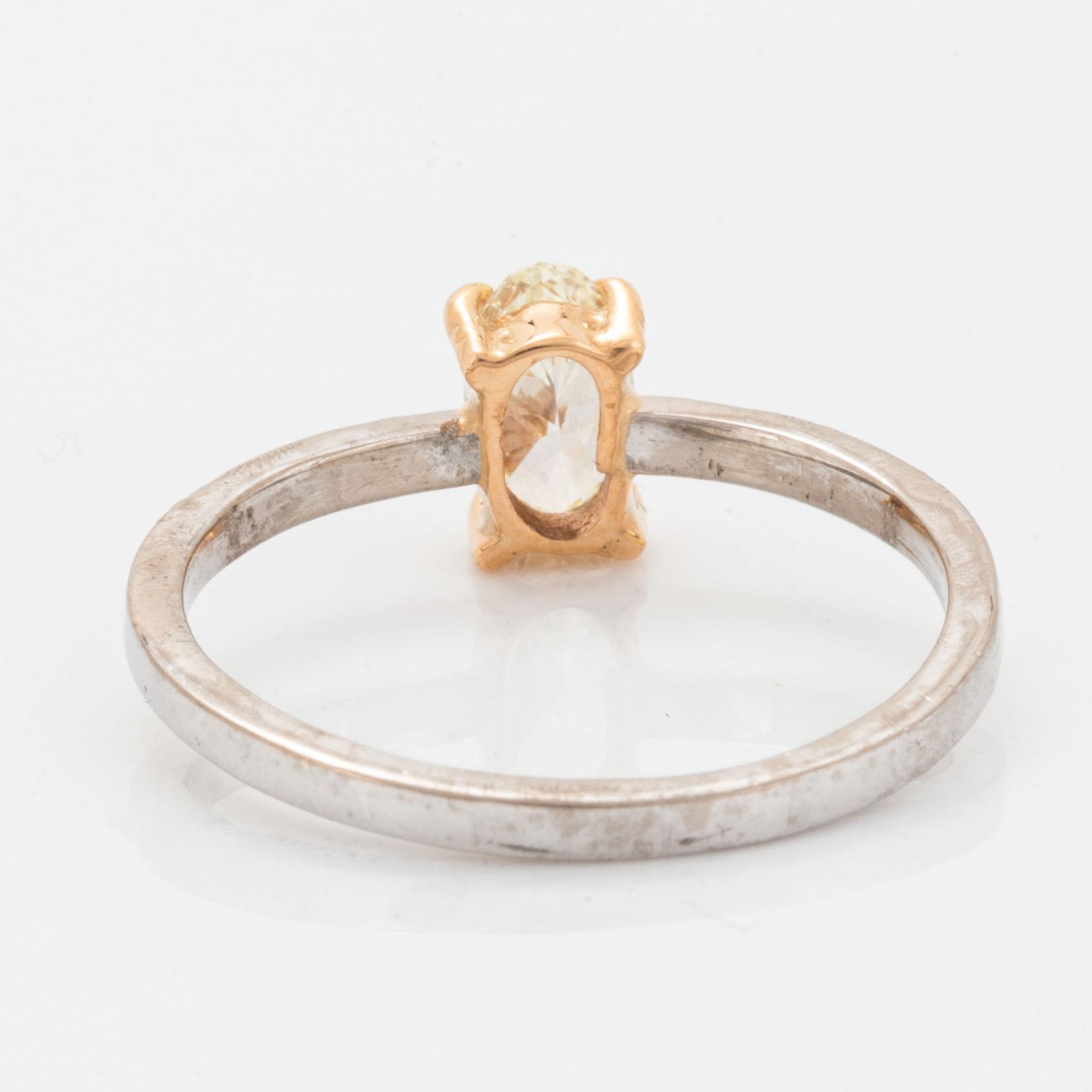 Oval diamond and brilliant-cut diamond ring.