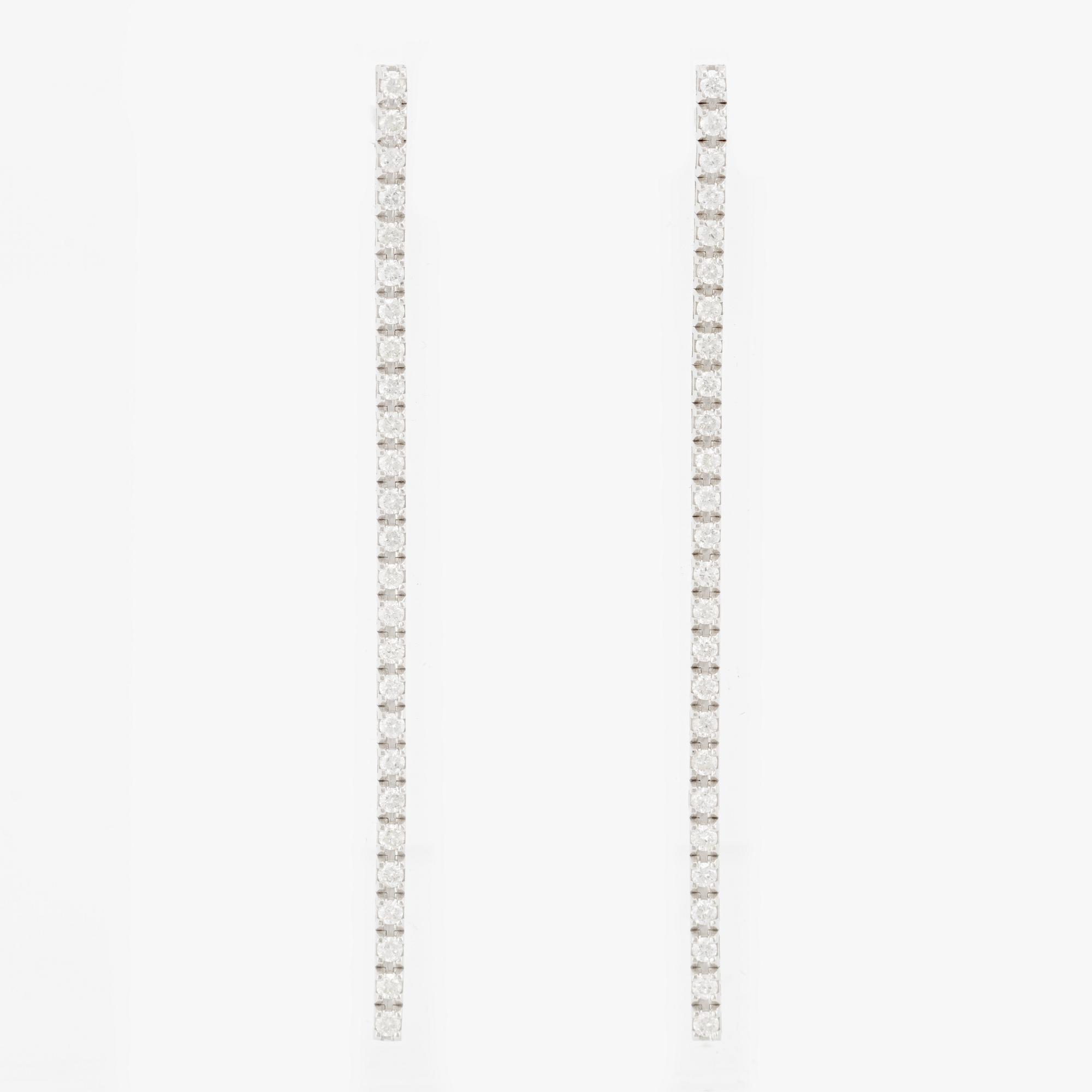 Brilliant-cut diamond line earrings.